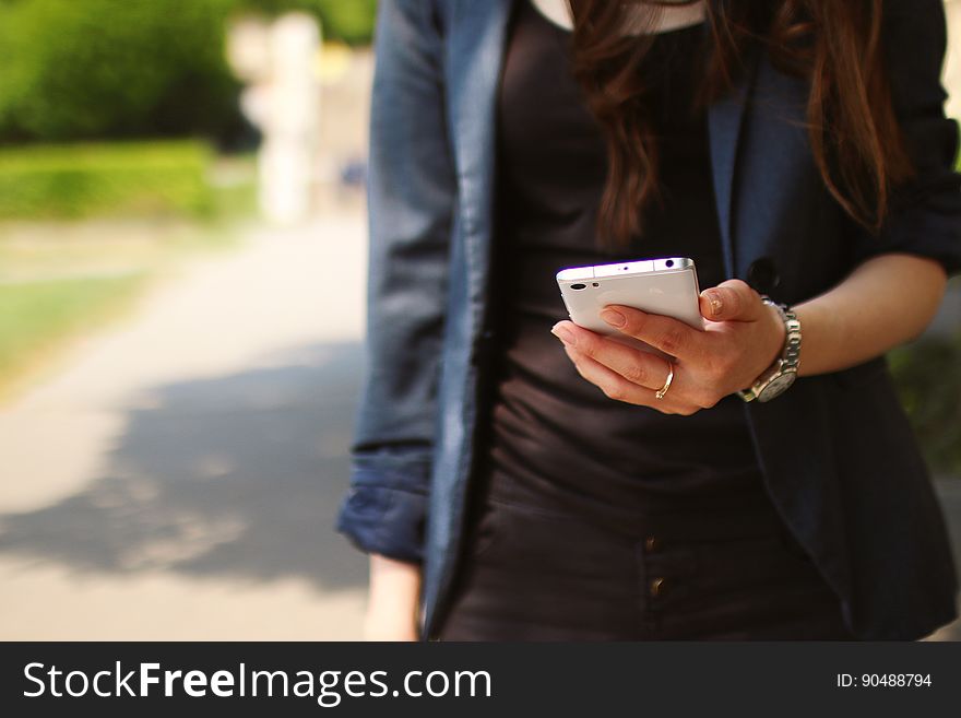 Woman Holding White Smartphone