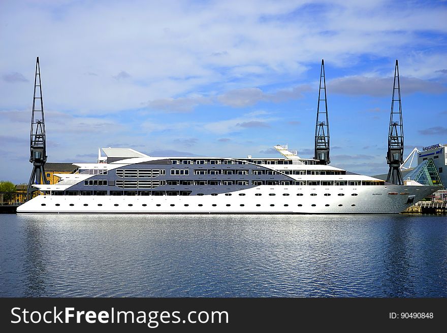 A large luxury yacht on the sea near the docks. A large luxury yacht on the sea near the docks.