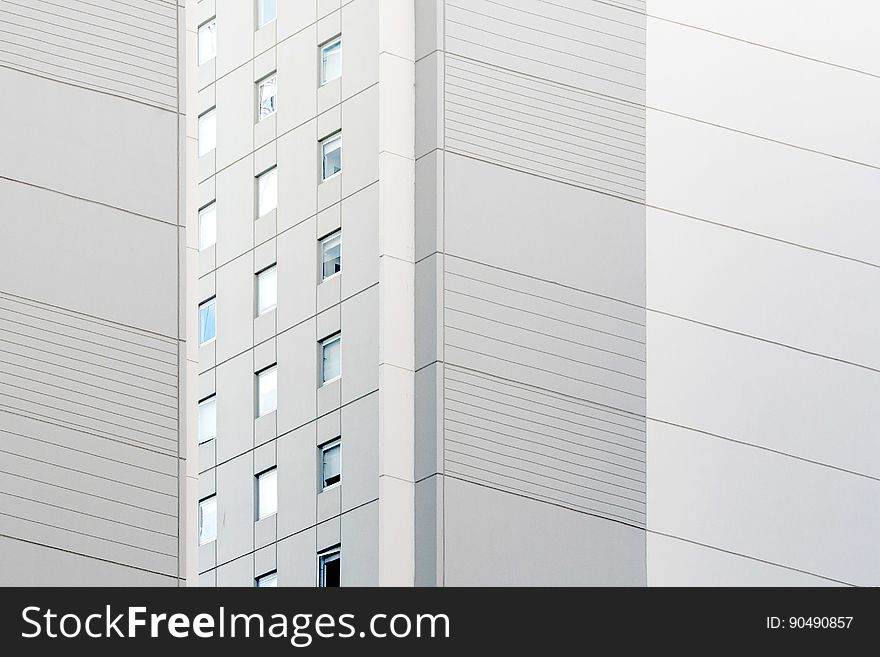 Background created by details of architecture of skyscraper showing windows and pale gray concrete panels in 3D. Background created by details of architecture of skyscraper showing windows and pale gray concrete panels in 3D.