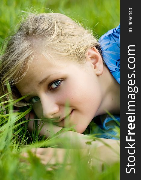 Beautiful young woman relaxing in the grass