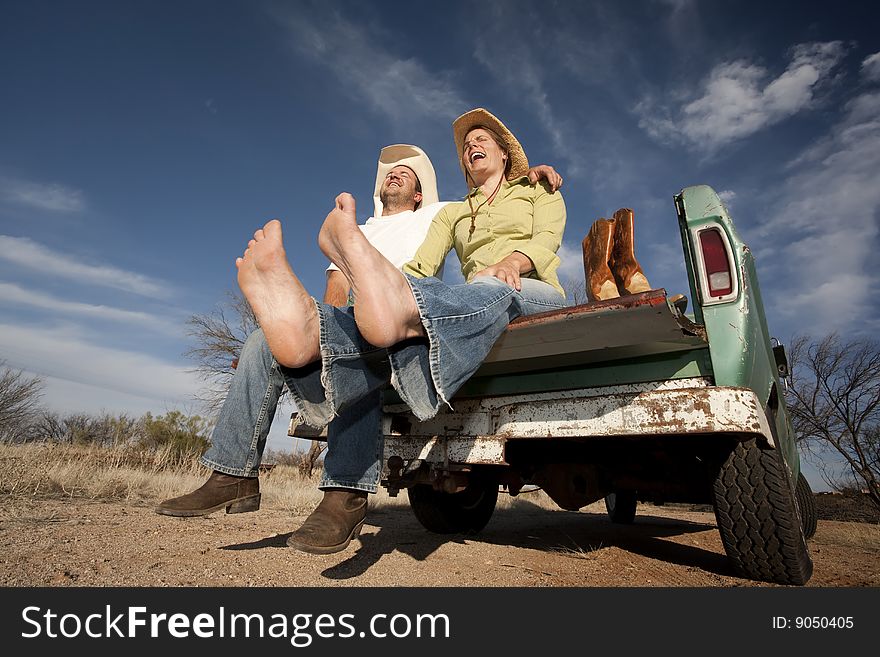 Cowboy and woman on pickup truck