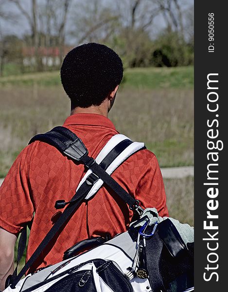 Young male golfer with carry bag. Young male golfer with carry bag.