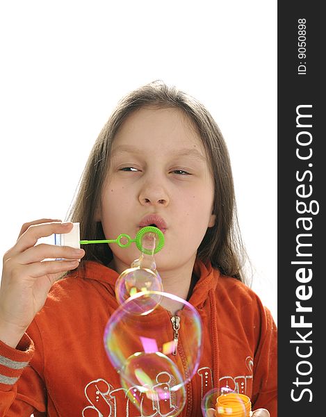 Young girl playing with water bubbles isolated on white background. Young girl playing with water bubbles isolated on white background