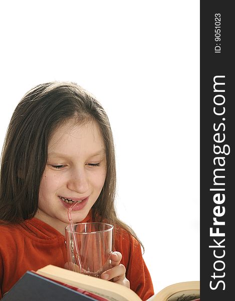 Young girl reading a book and drinking a fresh juice. Young girl reading a book and drinking a fresh juice