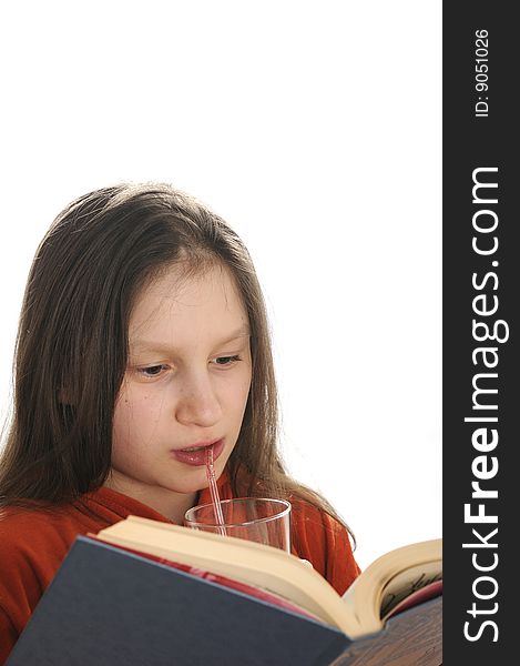 Young girl reading a book and drinking a fresh juice. Young girl reading a book and drinking a fresh juice