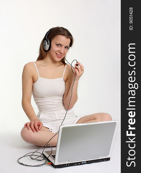 Young woman with headphones and laptop