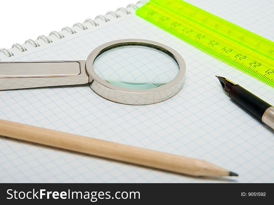 Fountain pen, magnifier, pencil and ruler isolated on the white. Fountain pen, magnifier, pencil and ruler isolated on the white