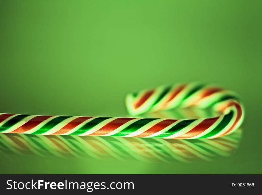 Colorful lollipop isolated on a green background