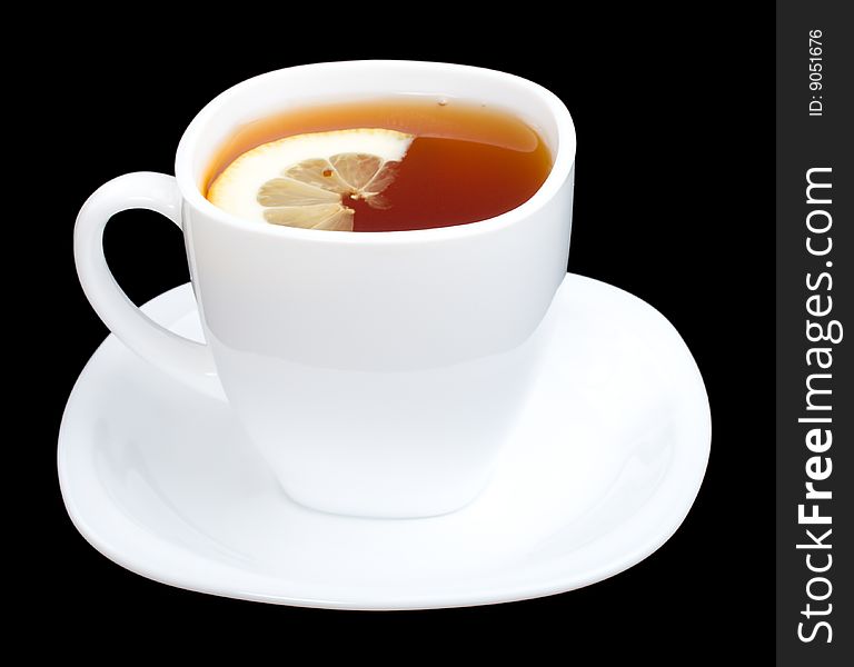 Cup of tea with lemon and saucer, isolated on black. Cup of tea with lemon and saucer, isolated on black