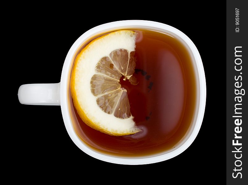 Cup of tea with lemon, view from above, isolated on black. Cup of tea with lemon, view from above, isolated on black