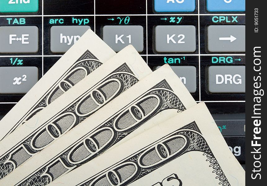 Close-up dollars over calculator