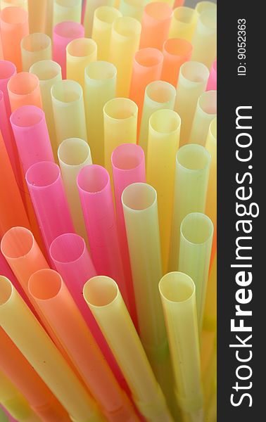 Close in shot of tops of colorful straws. Close in shot of tops of colorful straws