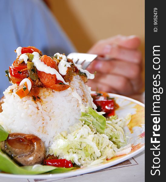 Appetizing rice dinner served, mushroom on fork. Appetizing rice dinner served, mushroom on fork