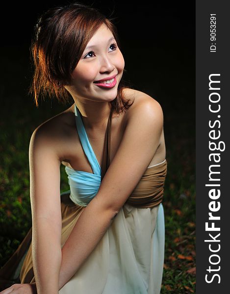 Beautiful Young Asian Woman Sitting In The Park.