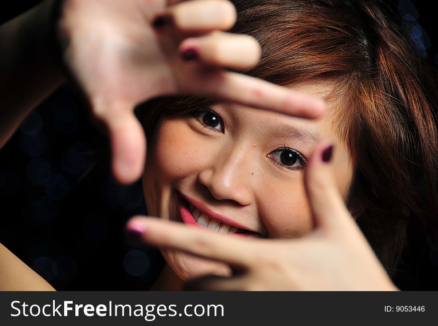 Beautiful young Asian Woman showing handsigns.