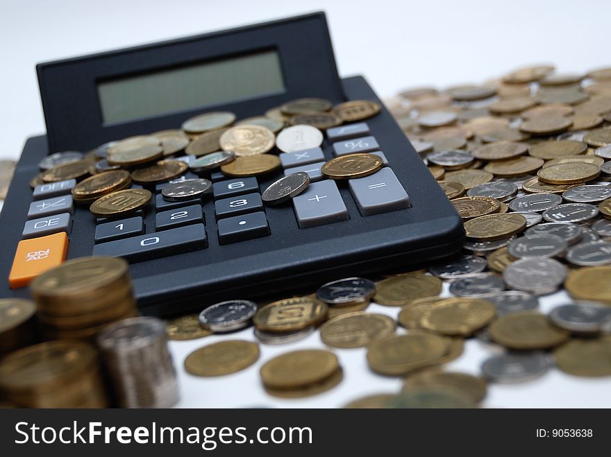 Calculator and different coins - financial symbol . Calculator and different coins - financial symbol ...