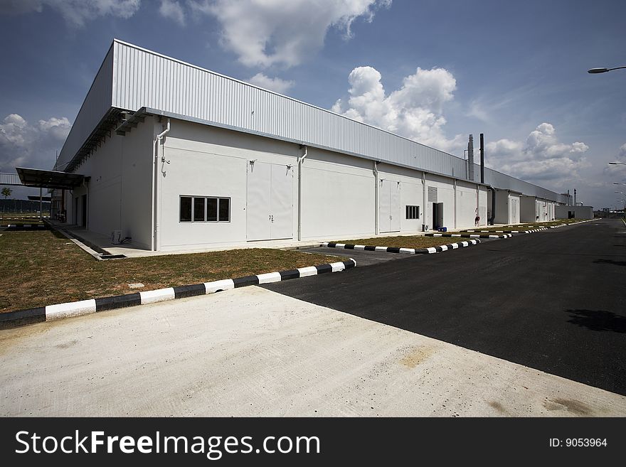 Wide angle view of factory building with blue sky