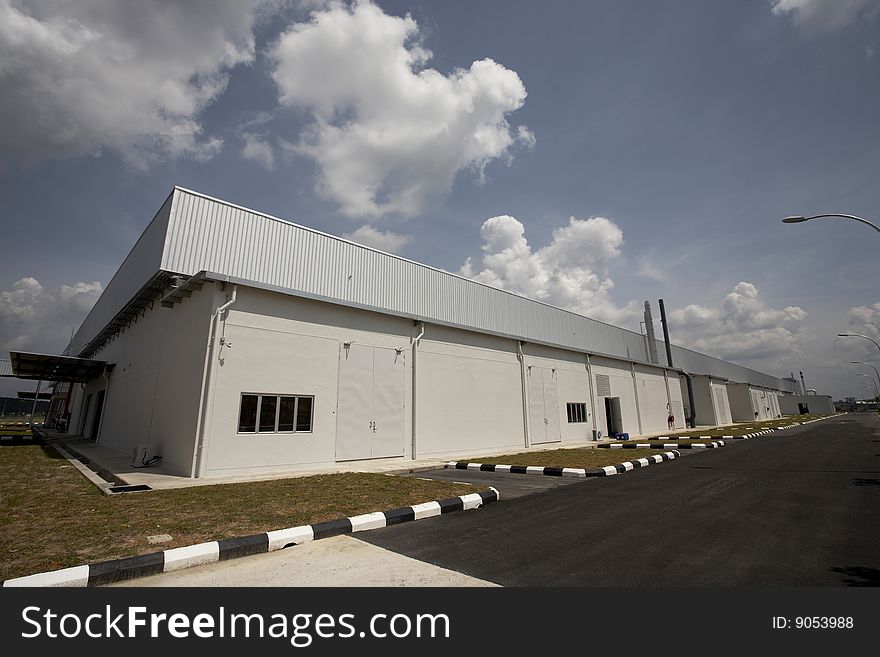 Wide angle view of factory building with blue sky
