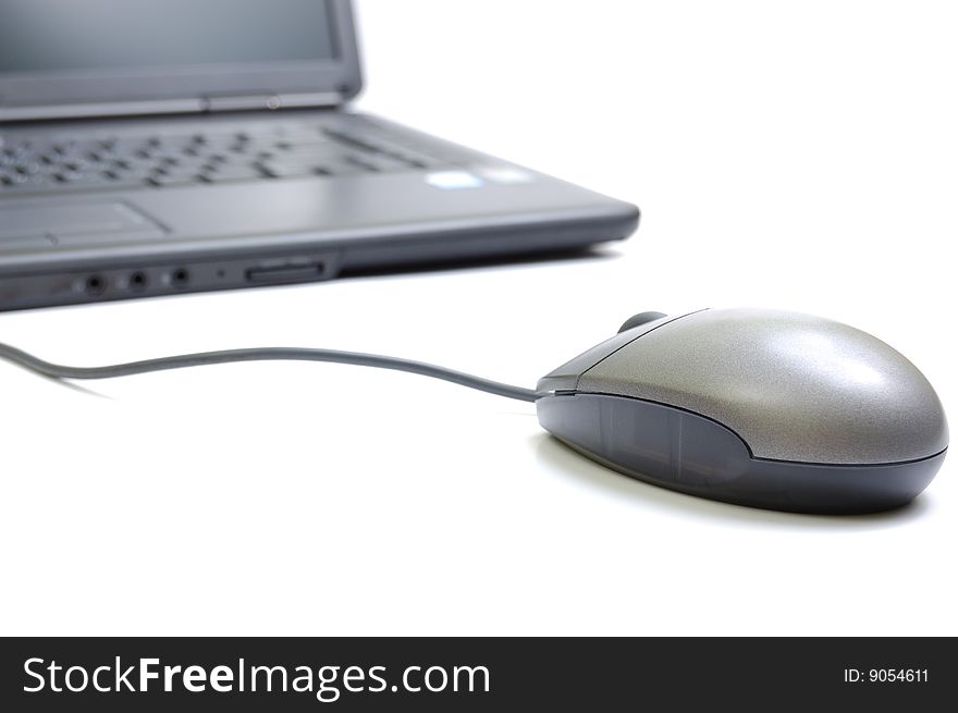 Laptop with mouse. Isolated on white.