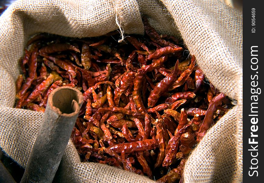 Brown burlap bag with dried red peppers