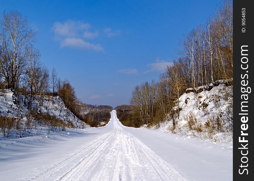 The Winter landscape road coverring snow in wood. The Winter landscape road coverring snow in wood
