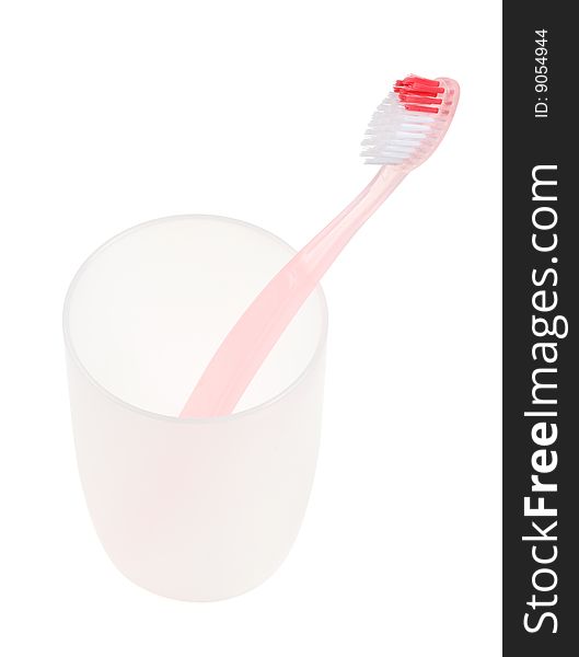 Pink toothbrush in glass. With clipping path.