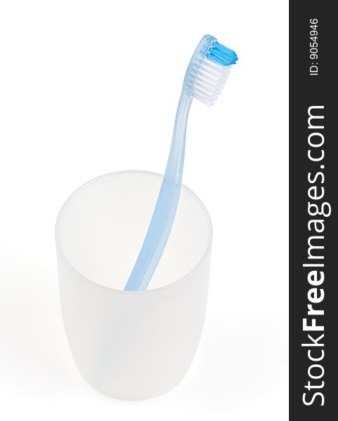Blue toothbrush in glass. With clipping path.