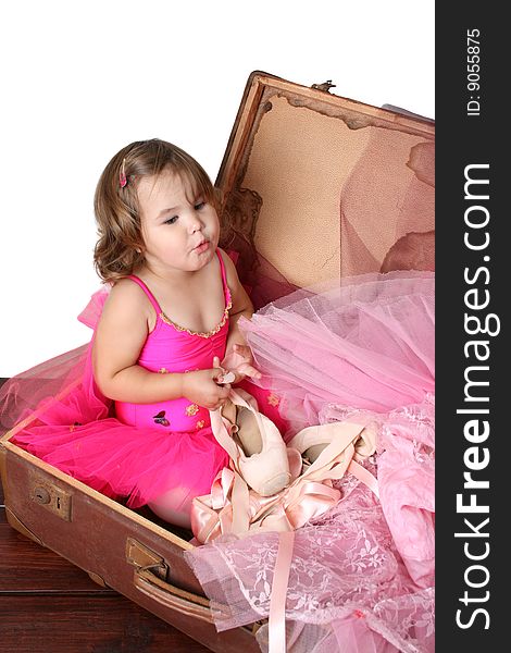 Little girl with short hair wearing a bright pink ballet outfit