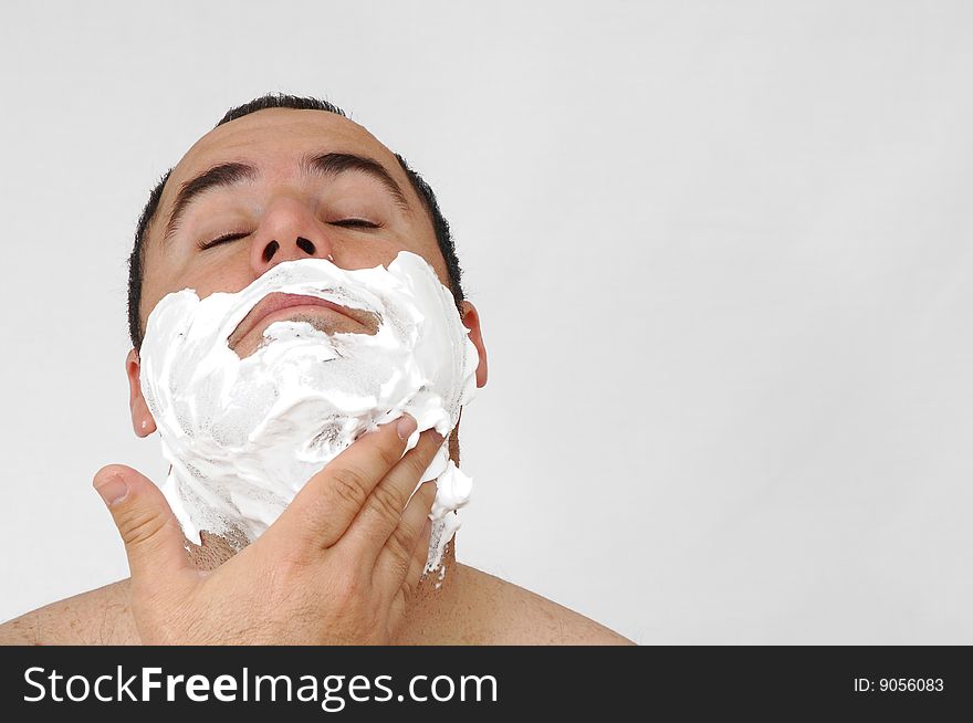 Man shaving isolated on gray background