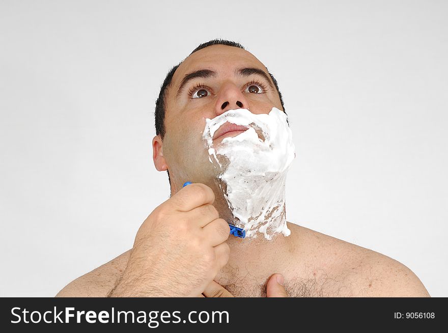 Man shaving isolated on gray background