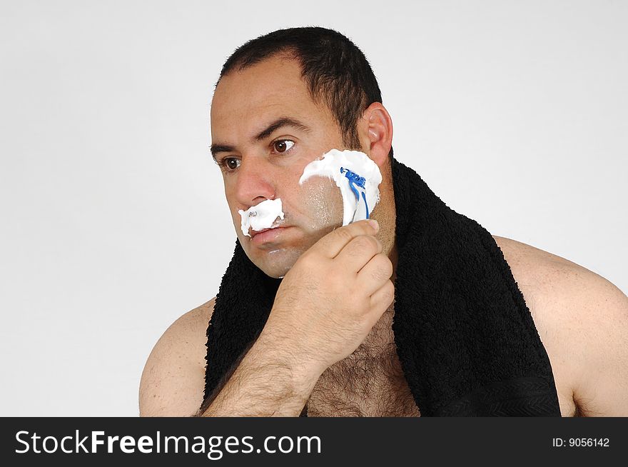 Man shaving isolated on gray background