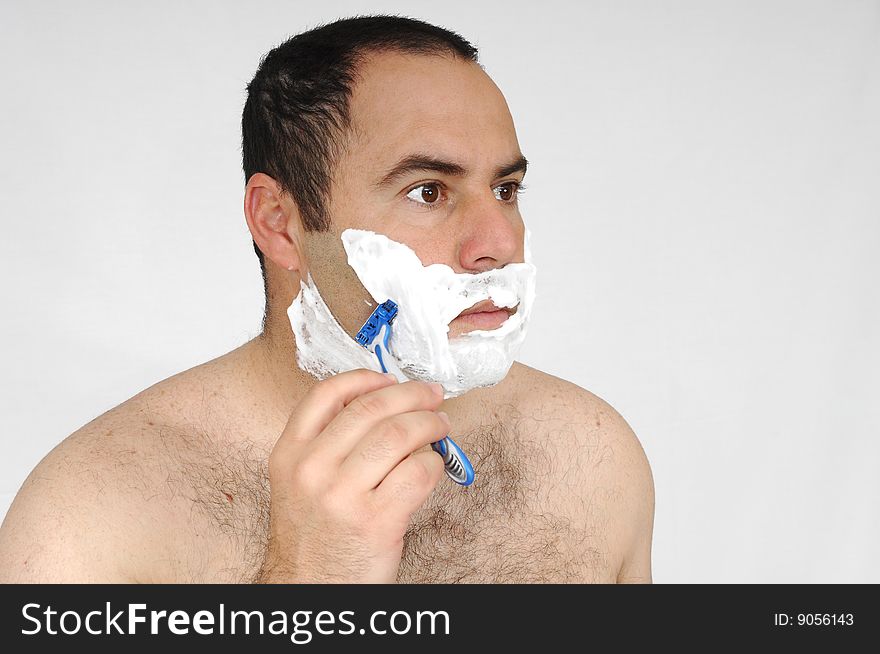 Man shaving isolated on gray background
