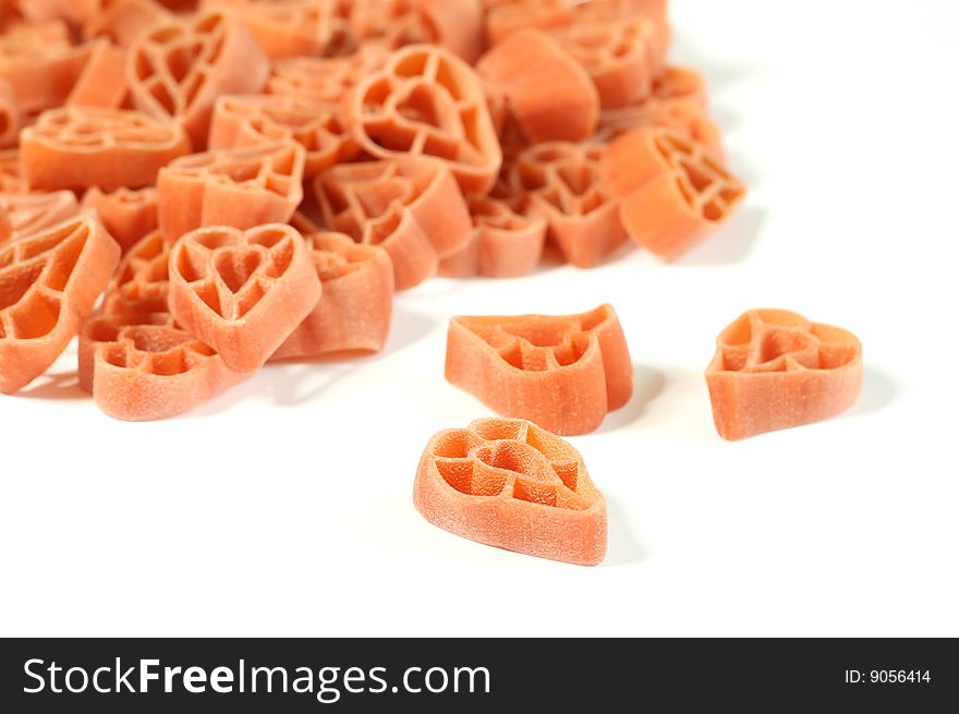 red uncooked pasta, isolated on white background