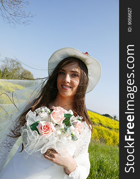 Portrait of a young woman in a wedding dress holding a bouquet of flowers. Portrait of a young woman in a wedding dress holding a bouquet of flowers