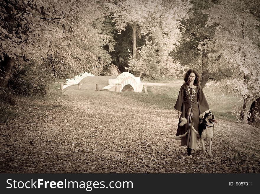 Lady in medieval dress and dog in the forest. Lady in medieval dress and dog in the forest