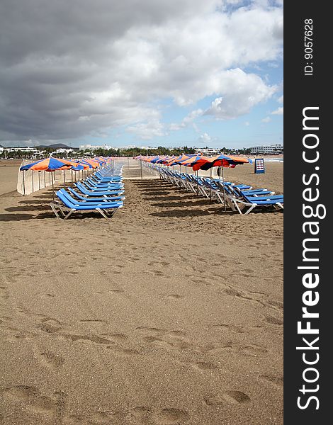 Rows of deck chairs on beach