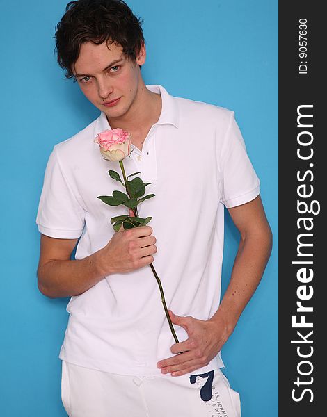 young man with rose looking seriously