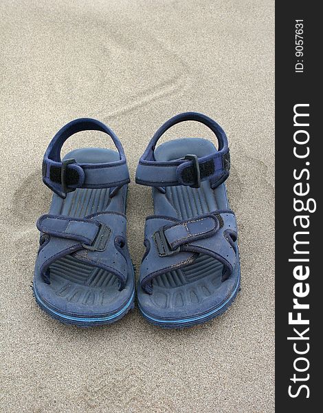Blue beach sandals on the sand