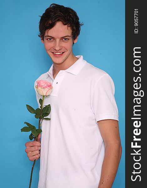 young man with rose standing and smiling