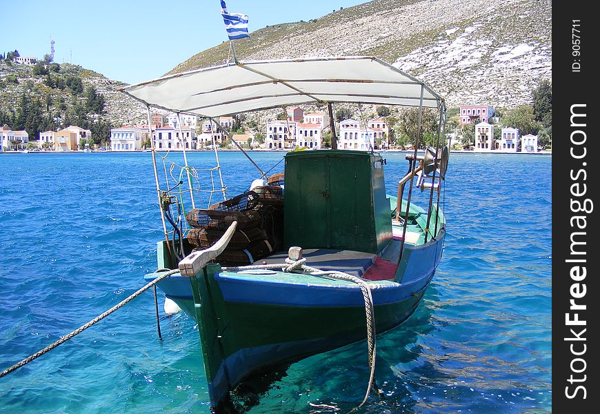 A colourful fishing boat sitting in the harbour of the Greek island of Kastellorizo.