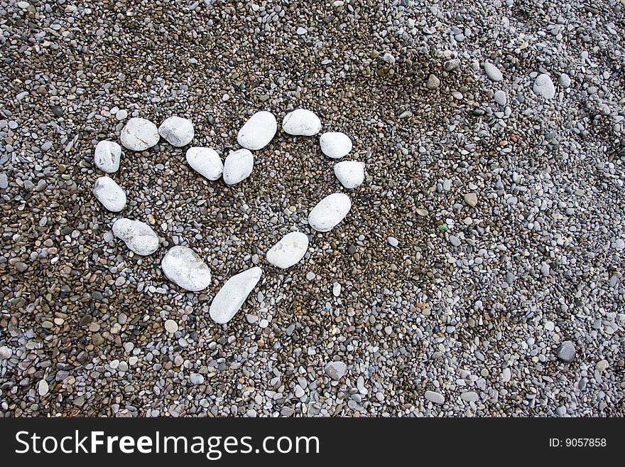 Shape of heart from white stones on the beach