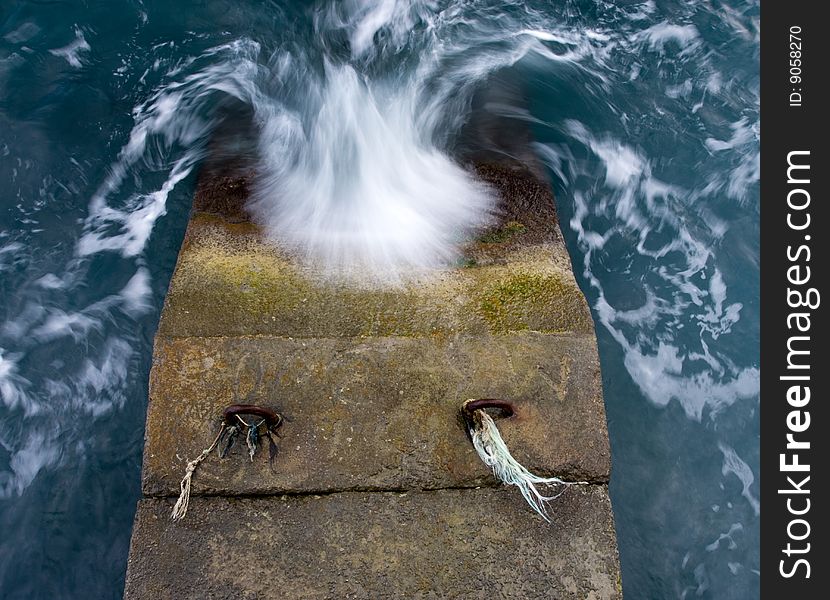 Blue sea with wave and brown stone pier. Blue sea with wave and brown stone pier