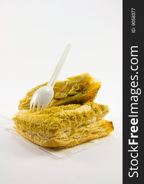 Single chicken curry pasty with plastic white fork on a white background. Single chicken curry pasty with plastic white fork on a white background