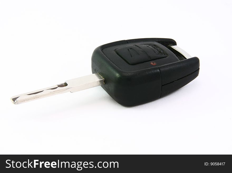 Black remote car ignition key on white background.