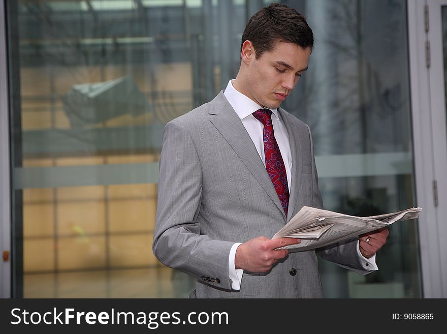 young business man reads newspaper,