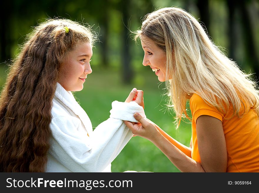 Happy mom and daughter smiling outdoors