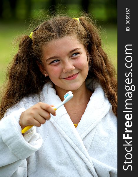 Funny little cute girl brushing teeth outdoors. Funny little cute girl brushing teeth outdoors