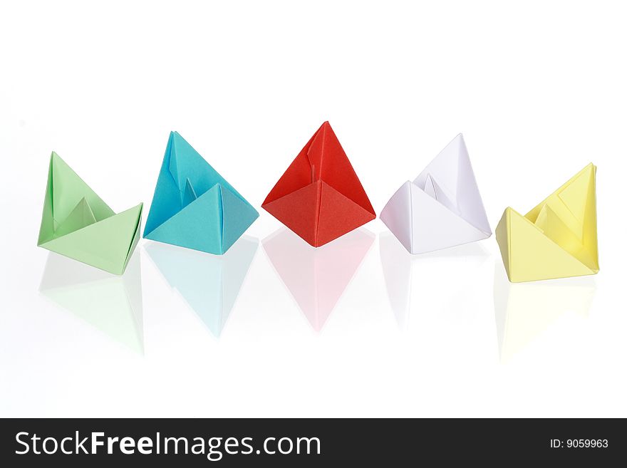 Five colorful paper boats isolated on white with clipping path