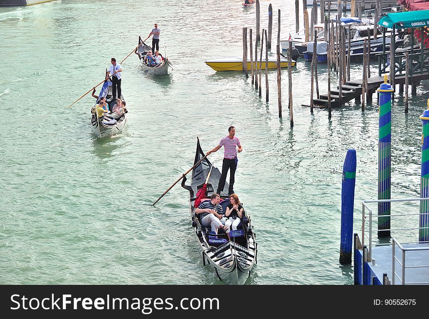 The water streets of Venice are canals which are navigated by gondolas and other small boats. During daylight hours the canals, bridges, and streets of Venice are full of tourists eager to experience the romance of this great travel destination. As night engulfs the town, tourists enjoy some fine dining at one of the many restaurants, leaving the waterways and streets quiet. The gondola is a traditional, flat-bottomed Venetian rowing boat, well suited to the conditions of the Venetian Lagoon. For centuries gondolas were once the chief means of transportation and most common watercraft within Venice. In modern times the iconic boats still have a role in public transport in the city, serving as ferries over the Grand Canal. They are also used in special regattas &#x28;rowing races&#x29; held amongst gondoliers. Their main role, however, is to carry tourists on rides throughout the canals. Gondolas are hand made using 8 different types of wood &#x28;fir, oak, cherry, walnut, elm, mahogany, larch and lime&#x29; and are composed of 280 pieces. The oars are made of beech wood. The left side of the gondola is longer than the right side. This asymmetry causes the gondola to resist the tendency to turn toward the left at the forward stroke. The water streets of Venice are canals which are navigated by gondolas and other small boats. During daylight hours the canals, bridges, and streets of Venice are full of tourists eager to experience the romance of this great travel destination. As night engulfs the town, tourists enjoy some fine dining at one of the many restaurants, leaving the waterways and streets quiet. The gondola is a traditional, flat-bottomed Venetian rowing boat, well suited to the conditions of the Venetian Lagoon. For centuries gondolas were once the chief means of transportation and most common watercraft within Venice. In modern times the iconic boats still have a role in public transport in the city, serving as ferries over the Grand Canal. They are also used in special regattas &#x28;rowing races&#x29; held amongst gondoliers. Their main role, however, is to carry tourists on rides throughout the canals. Gondolas are hand made using 8 different types of wood &#x28;fir, oak, cherry, walnut, elm, mahogany, larch and lime&#x29; and are composed of 280 pieces. The oars are made of beech wood. The left side of the gondola is longer than the right side. This asymmetry causes the gondola to resist the tendency to turn toward the left at the forward stroke.