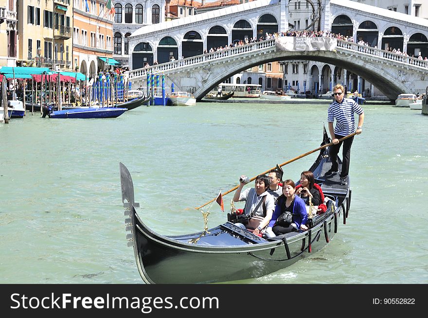 The water streets of Venice are canals which are navigated by gondolas and other small boats. During daylight hours the canals, bridges, and streets of Venice are full of tourists eager to experience the romance of this great travel destination. As night engulfs the town, tourists enjoy some fine dining at one of the many restaurants, leaving the waterways and streets quiet. The gondola is a traditional, flat-bottomed Venetian rowing boat, well suited to the conditions of the Venetian Lagoon. For centuries gondolas were once the chief means of transportation and most common watercraft within Venice. In modern times the iconic boats still have a role in public transport in the city, serving as ferries over the Grand Canal. They are also used in special regattas &#x28;rowing races&#x29; held amongst gondoliers. Their main role, however, is to carry tourists on rides throughout the canals. Gondolas are hand made using 8 different types of wood &#x28;fir, oak, cherry, walnut, elm, mahogany, larch and lime&#x29; and are composed of 280 pieces. The oars are made of beech wood. The left side of the gondola is longer than the right side. This asymmetry causes the gondola to resist the tendency to turn toward the left at the forward stroke. The water streets of Venice are canals which are navigated by gondolas and other small boats. During daylight hours the canals, bridges, and streets of Venice are full of tourists eager to experience the romance of this great travel destination. As night engulfs the town, tourists enjoy some fine dining at one of the many restaurants, leaving the waterways and streets quiet. The gondola is a traditional, flat-bottomed Venetian rowing boat, well suited to the conditions of the Venetian Lagoon. For centuries gondolas were once the chief means of transportation and most common watercraft within Venice. In modern times the iconic boats still have a role in public transport in the city, serving as ferries over the Grand Canal. They are also used in special regattas &#x28;rowing races&#x29; held amongst gondoliers. Their main role, however, is to carry tourists on rides throughout the canals. Gondolas are hand made using 8 different types of wood &#x28;fir, oak, cherry, walnut, elm, mahogany, larch and lime&#x29; and are composed of 280 pieces. The oars are made of beech wood. The left side of the gondola is longer than the right side. This asymmetry causes the gondola to resist the tendency to turn toward the left at the forward stroke.